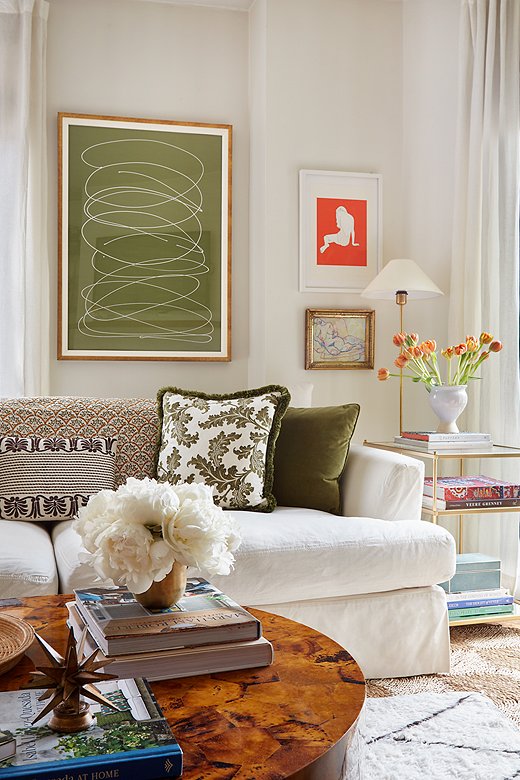 The white slipcovered sofa serves as a blank canvas for pillows and throws in a variety of complementary colors and prints. More pattern comes via the layered rugs. Find a similar Moroccan-style rug here. 
